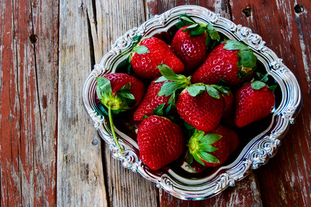 Fresh strawberries on vintage metal plate.の写真素材