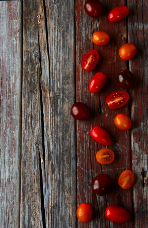 top view of fresh tomatoes on rustic wooden table with copy spaceの写真素材
