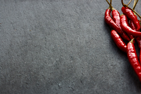 Chili Peppers over dark grey background. Selective focus. Copy space.の写真素材