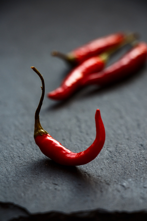 Red Chili Hot Peppers over dark grey background. Selective focusの写真素材