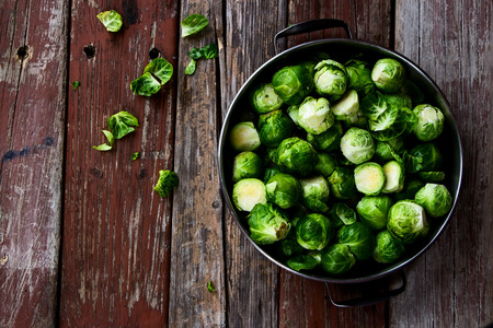 Fresh brussel sprouts over rustic wooden texture. Top view.の写真素材