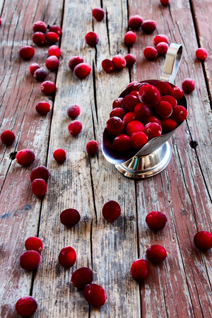 Cranberries over rustic wooden background. Selective focusの写真素材