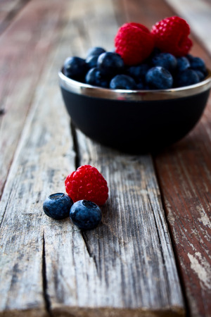 Fresh Berries on Rustic Wooden Backgroundの写真素材