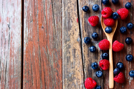 Top view of Berries with spoon on Rustic Wooden Backgroundの写真素材