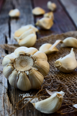 Garlic on jute and wooden texture. Selective focus.の写真素材