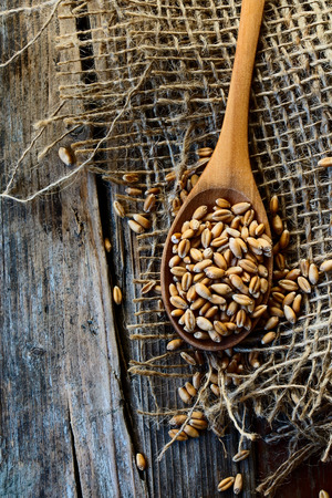 Wheat grain on rustic wooden background. Top view.の写真素材