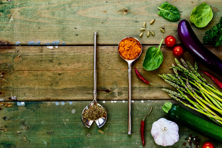 Spices, herbs and ingredients on old wooden background.の写真素材