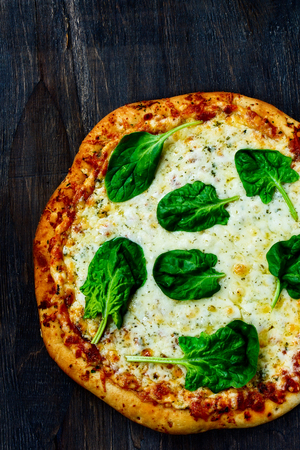Delicious italian pizza served on wooden background. Top view.の写真素材