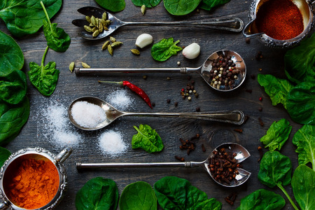 Food Elements - Herbs and spices selection, old metal spoons and dark wood - cooking, healthy eating. Top view.の写真素材
