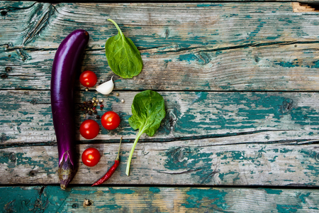 Fresh eggplants and herbs on rustic Wooden Background.の写真素材