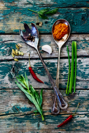 Herbs and spices selection - old metal spoons and rustic wooden backgroundの写真素材