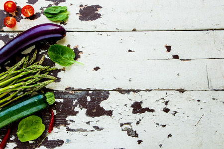 Aromatic herbs and vegetables on a old Wooden Background.の写真素材