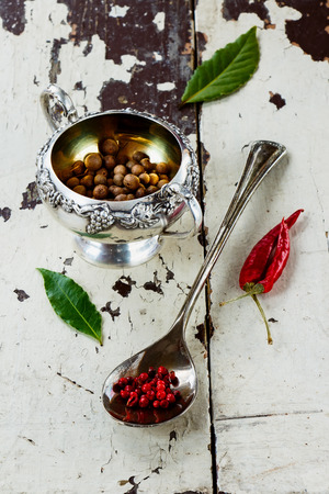 Colorful Spices in vintage spoon and cup over rustic wooden background.の写真素材