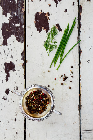 Spices  in vintage metal cup over old wooden table. Top view.の写真素材