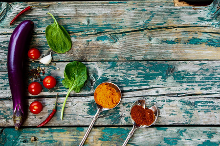 Organic eggplant and herbs on rustic Wooden Background. Vegetarian food, health or cooking concept. Top view.の写真素材