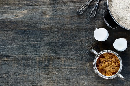 Baking background with copy space - brown sugar and flour on wooden texture. Top view.の写真素材