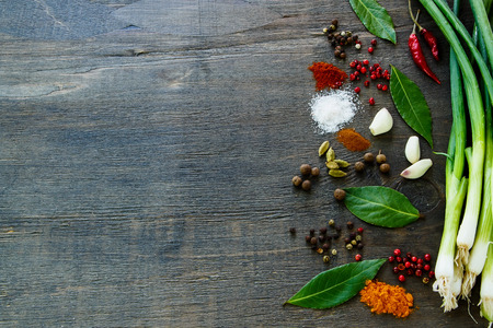 Colorful herbs and spices selection on dark wooden table. Background with space for text.の写真素材