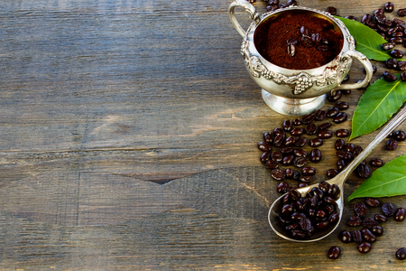 Coffee beans and vintage spoon on dark wooden table. Background with space for text.の写真素材