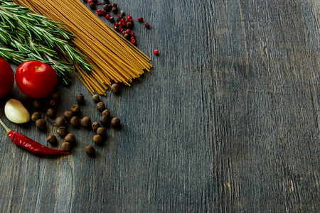 Background with Italian ingredients for cooking over dark wooden board (with easy removable sample text).の写真素材