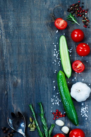Cooking background with ingredients on dark wooden table with space for text. Vegetarian food, health or cooking concept.の写真素材