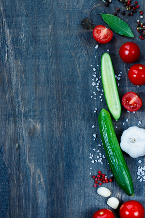 Food background with ingredients on dark wooden table with space for text. Vegetarian food, health or cooking concept.の写真素材