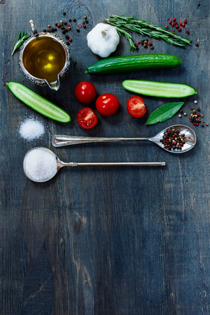 Spices and healthy bio vegetables on dark wooden background with space for text. Vegetarian food, health or cooking concept.の写真素材