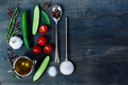 Spices selection and ingredients on dark wooden background with space for text. Vegetarian food, health or cooking concept.の写真素材