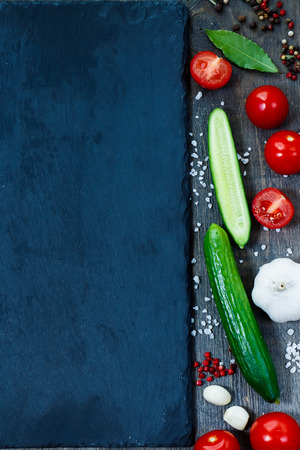 Close up of ingredients on slate and wooden background with space for text. Vegetarian food, health or cooking concept.の写真素材