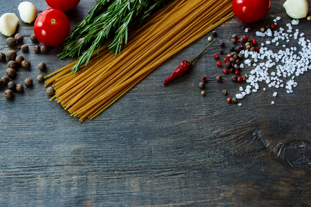 Background with Italian food. Ingredients for cooking over dark wooden board (with easy removable sample text).の写真素材