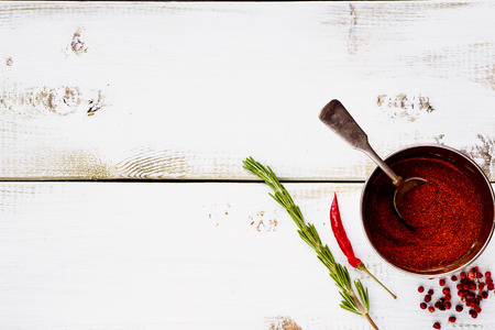 Spices in vintage cup. Herbs and spices selection - old metal cup and white wooden background with space for text. Cooking, food or health concept.の写真素材