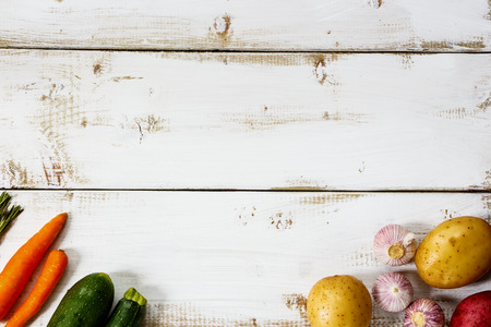 Healthy food background. Organic ingredients for cooking on white wooden board with space for text. Vegetarian food, health or cooking concept.の写真素材