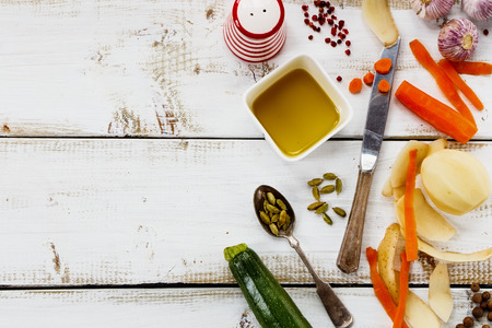Cooking ingredients on white wooden background. Vegetarian food, health or cooking concept. Rural still life from above with free text space.の写真素材