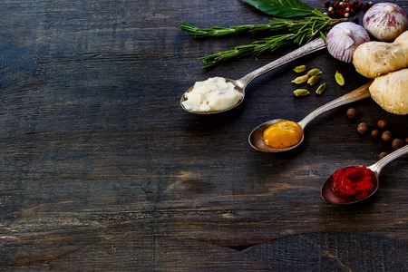 Various Spices and Sauces on rustic wooden board. Cooking, food or health concept. Space for text.の写真素材