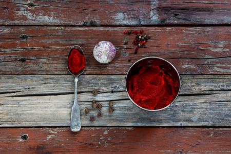 Top view of ingredients or recipe on rustic wooden background. Tomato puree, garlic, salt and pepper from above - cooking food. Background with free text space.の写真素材