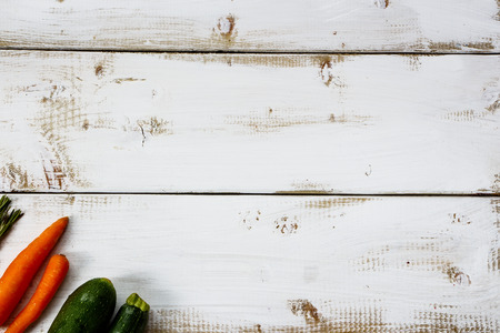Food background. Organic ingredients for cooking on white wooden board with space for text. Vegetarian food, health or cooking concept.の写真素材