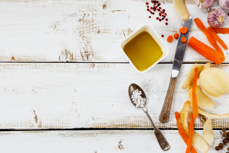 Top view of ingredients for cooking on white wooden background. Vegetarian food, health or cooking concept. Rural still life with free text space.の写真素材