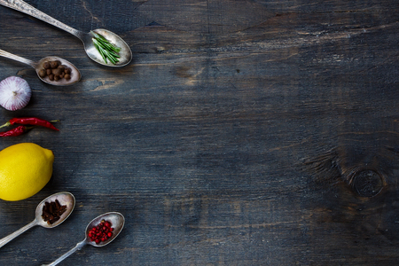 Spices on wood. Herbs and spices selection - old metal spoons and rustic wooden background. Cooking, food or health concept.の写真素材