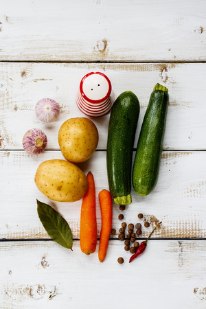 Healthy vegetables for cooking on white wooden background with space for text. Vegetarian food, health or cooking concept.の写真素材
