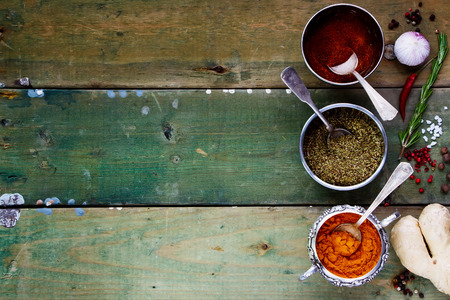 Background with Spices. Herbs and spices selection - old metal cups and rustic wooden board. Cooking, food or health concept. Space for textの写真素材