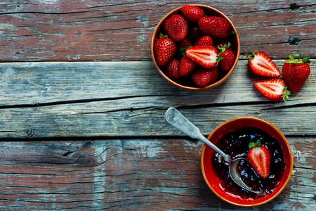 Background with Strawberry jam on rustic wooden board. Space for text.の写真素材
