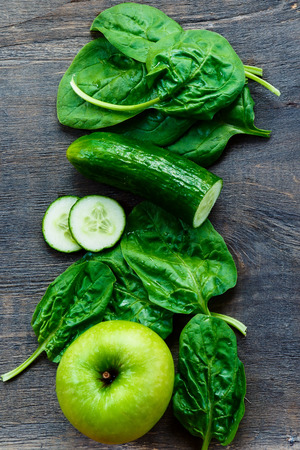 Close up of fresh green vegetables on dark wooden background. Detox, diet or healthy food concept.の写真素材