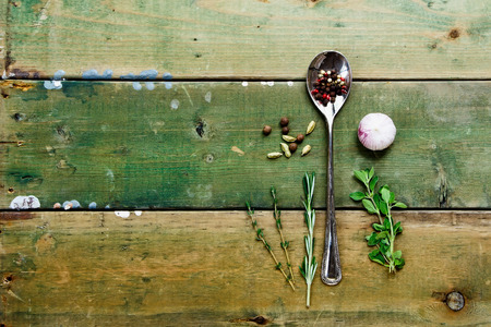 Fresh herbs, spice and garlic on rustic wooden table. Food background with space for text.の写真素材
