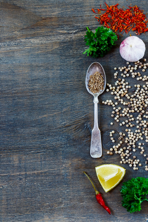Fresh spices and herbs selection over dark wooden background with space for text. Food and cuisine ingredients.の写真素材