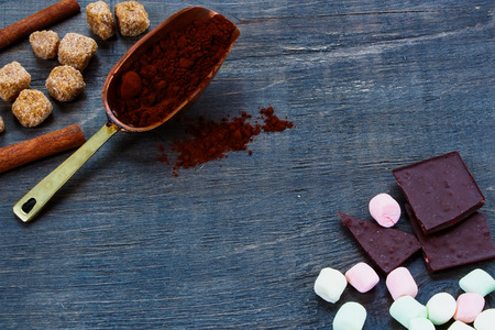 Background with ingredients for hot chocolate and vintage scoop over wood.の写真素材