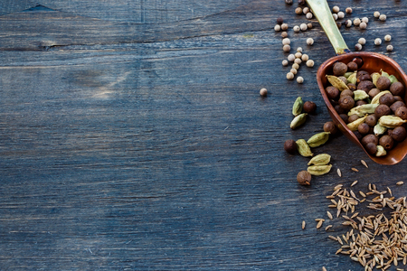 Vintage scoop with pepper mix, spices over dark wooden background with space for text. Cooking ingredients.の写真素材