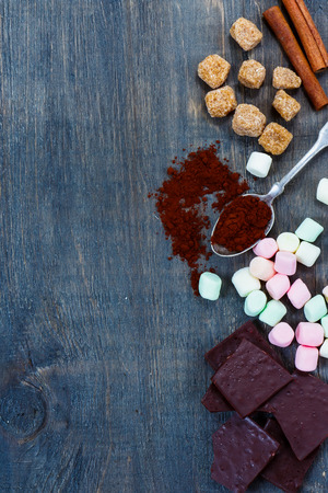 Close up of sweet ingredients for hot chocolate on dark wooden background with space for text. Still life.の写真素材