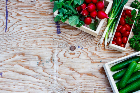 Fresh Bio vegetable in a box over wooden background.の写真素材