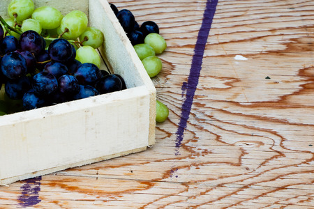 Organic Grapes in wooden box over old background. Selective focus.の写真素材