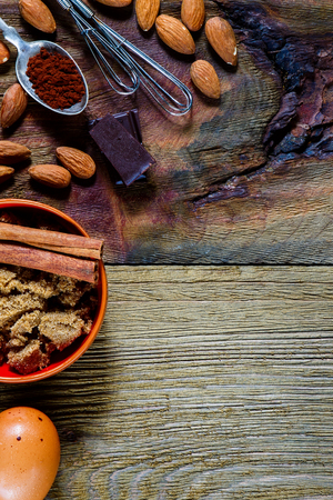Close up of brown sugar, egg, almonds, cacao for baking over rustic wooden background with space for text. Food or cooking concept. Top view.の写真素材