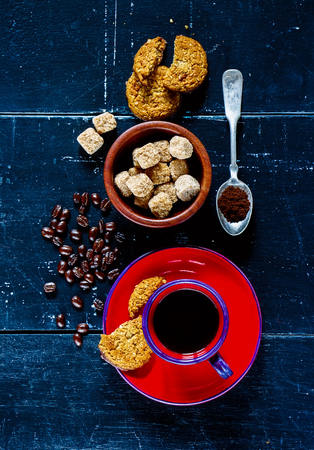 Background with espresso coffee, oatmeal cookies and sugar on dark vintage texture. Top view.の写真素材